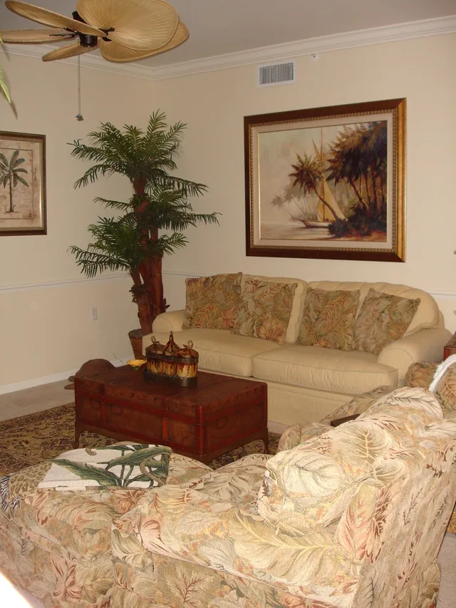 Second view of living room showing sofa & chairs.  Sofa is a pull out couch