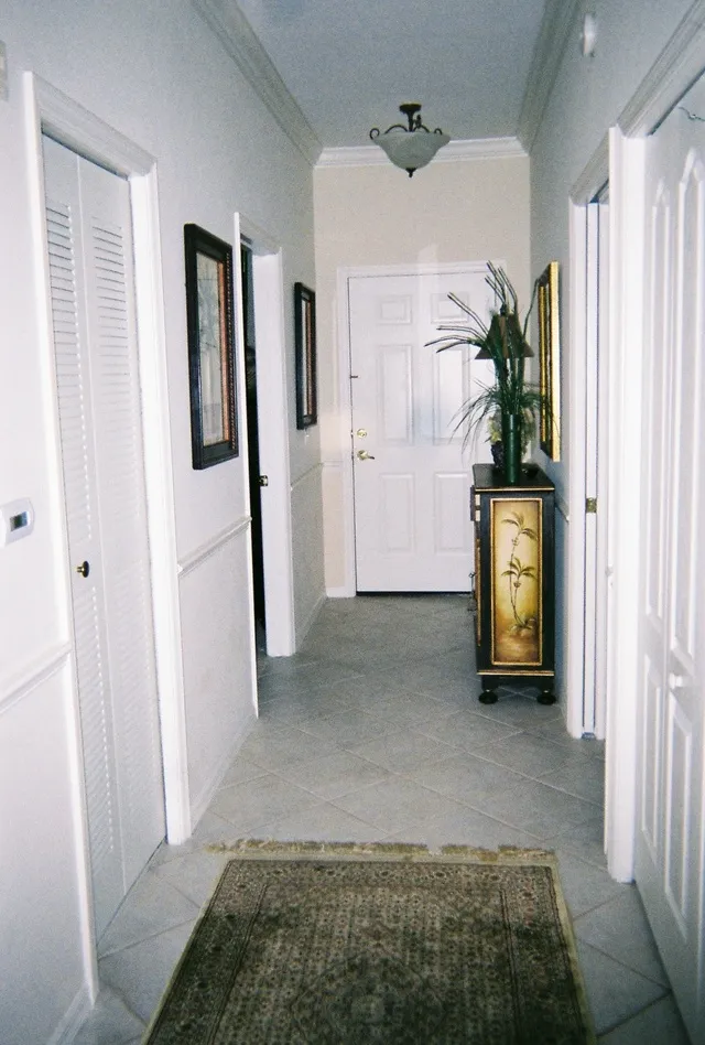 The entry hall is spacious. To the right are doors to laundry facilities.