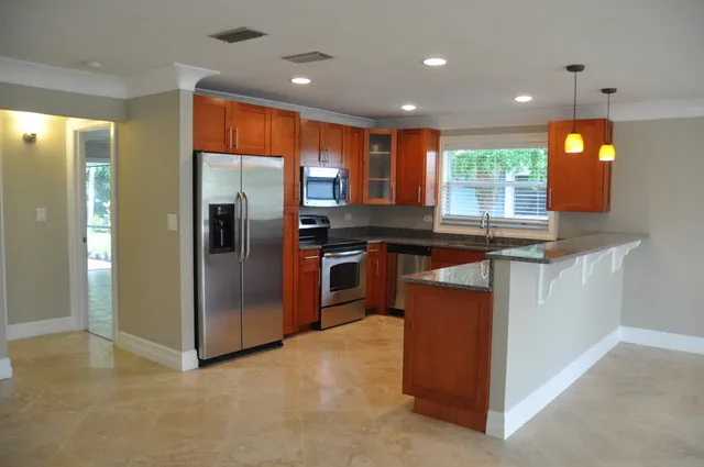 Kitchen - Open floor plan, stainless, granite, travertine. 