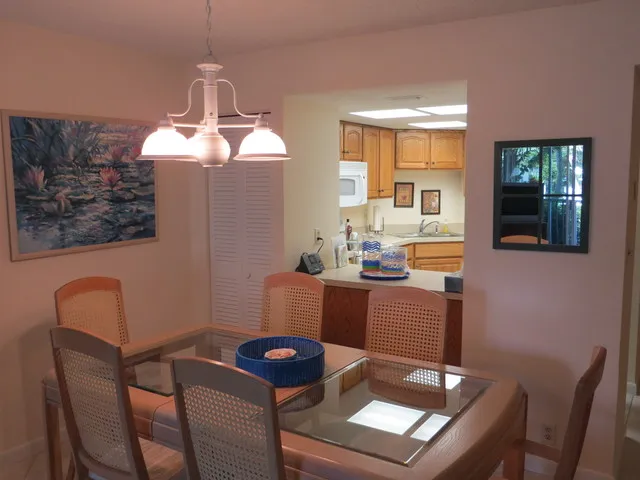 Dining area with kitchen in background