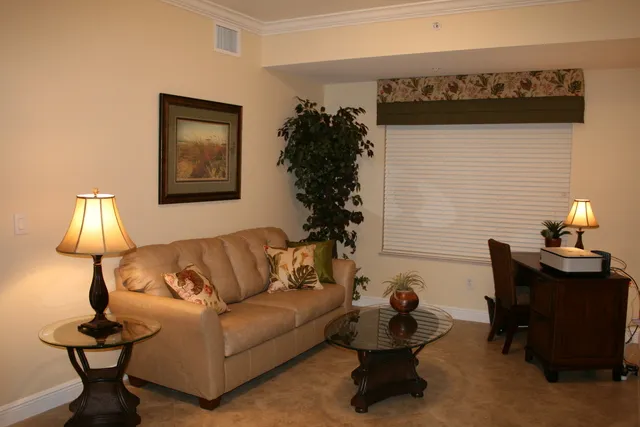 The den features a sleeper sofa and desk with wi fi and printer