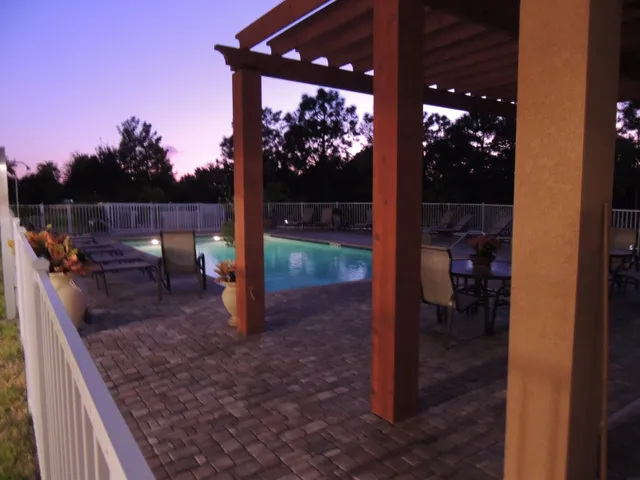 Beautiful pool area with gazebo and gas grill