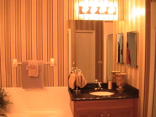 Master bathroom with designer wall paper, solid wood and marble cabinets