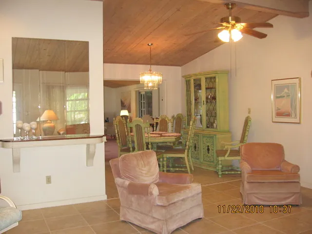 LIVING ROOM OVERLOOKING DINING ROOM.