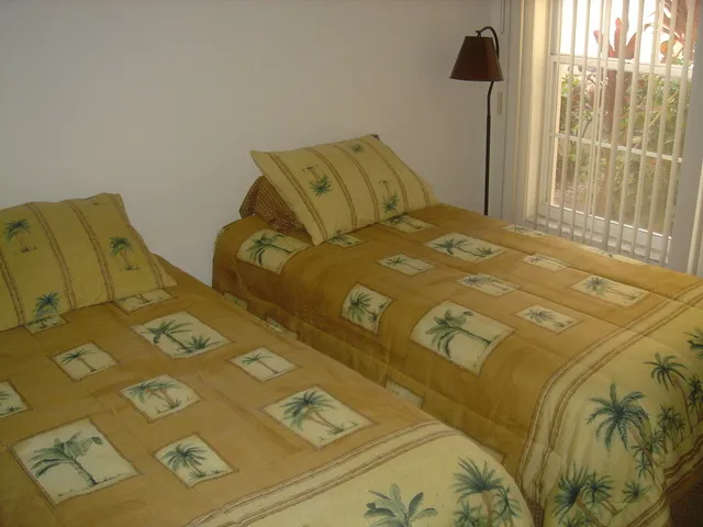 bedroom 2 with twin beds and night stand