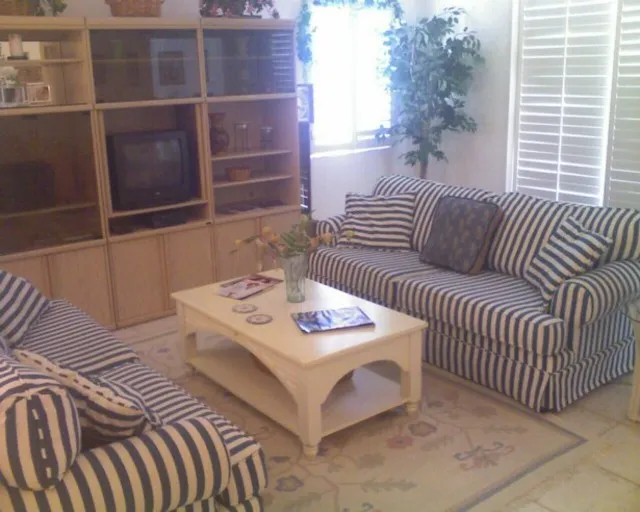 Living room with sliders to Lanai - open to kitchen & dining room