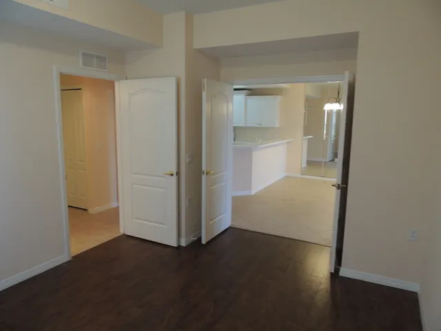 Den opens to the hallway and double doors to the dining/living room area