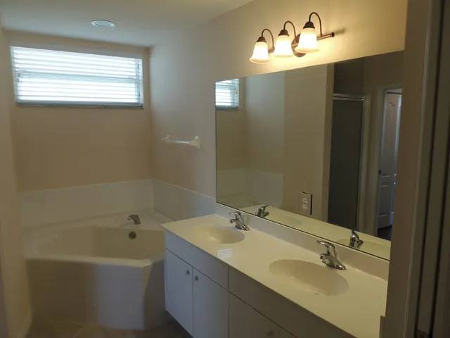 Master bath has two sinks, soaking tub, & walk in shower
