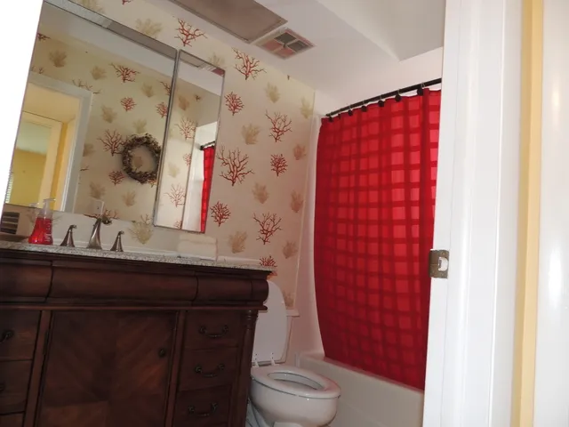 Guest bath features a tub/shower combo & decorated!