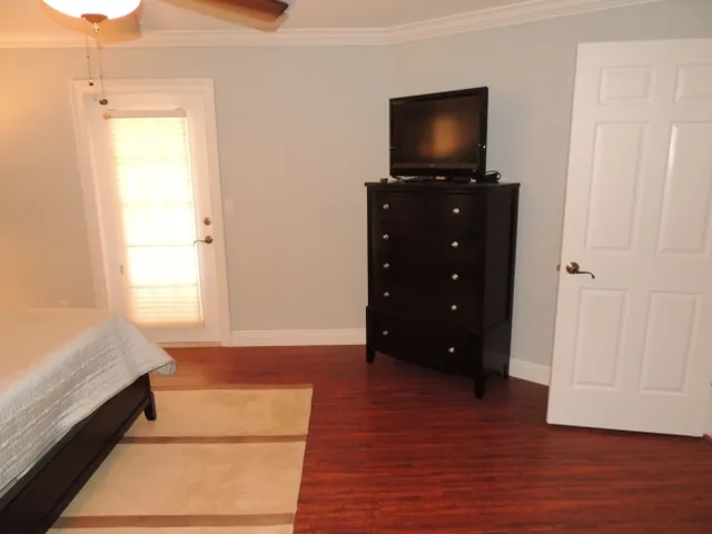 Master suite has hard wood floors and access to the lanai