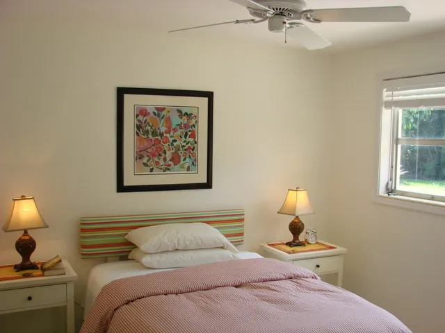 This guest room features a queen bed with views of pool