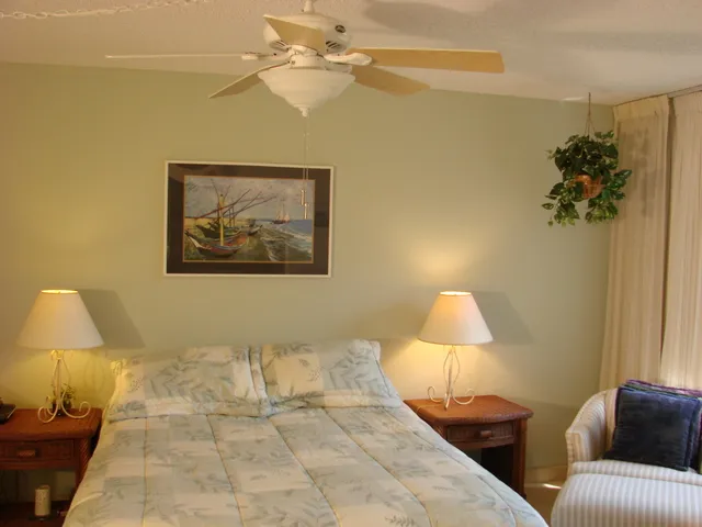 The master suite features a queen bed, chair, tv and private bath