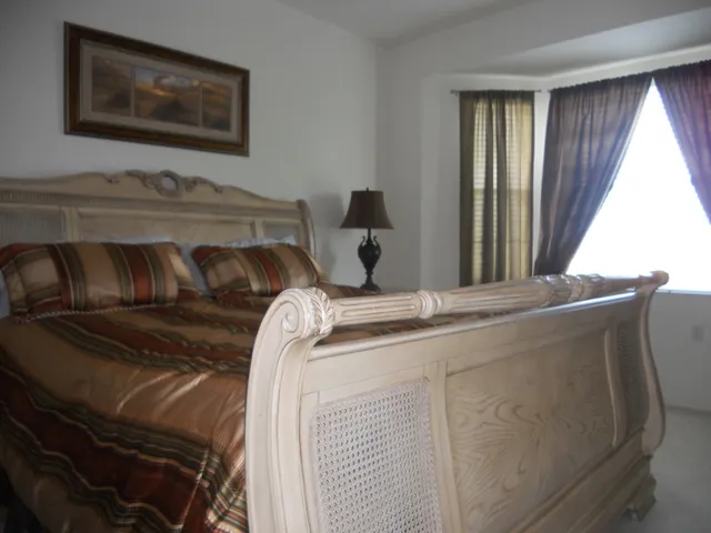 Master bedroom with kingsize bed, overlooking lake and golf course