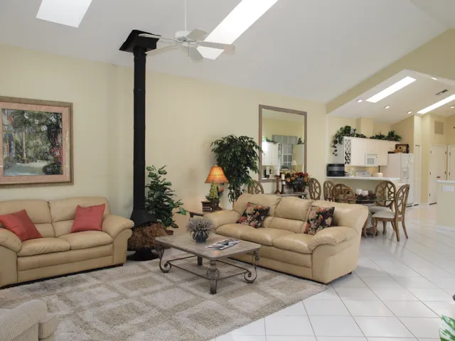 Great room design with vaulted ceilings, skylights and tile flooring.