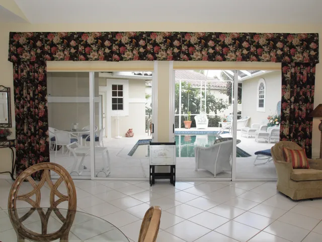 Double sliding doors out to the screened pool and cabana cottage.