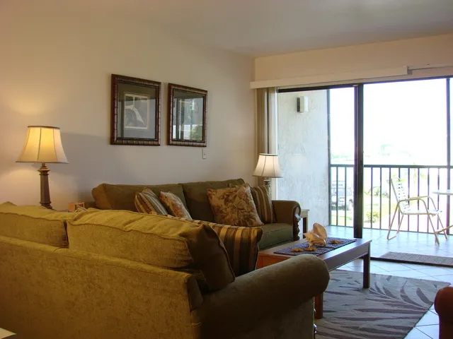 #104 living room has bay views and sliders to the screened lanai