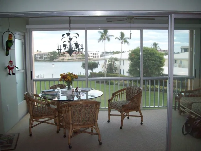 Informal eating area screened and sliding glass doors-lovely bay breeze.