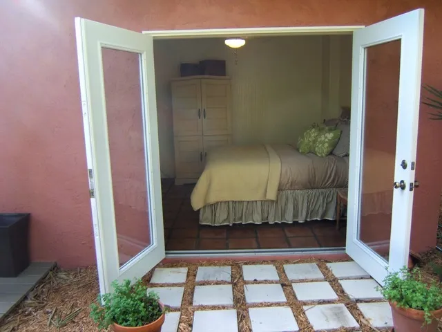 third bedroom opens to the private tropical back yard