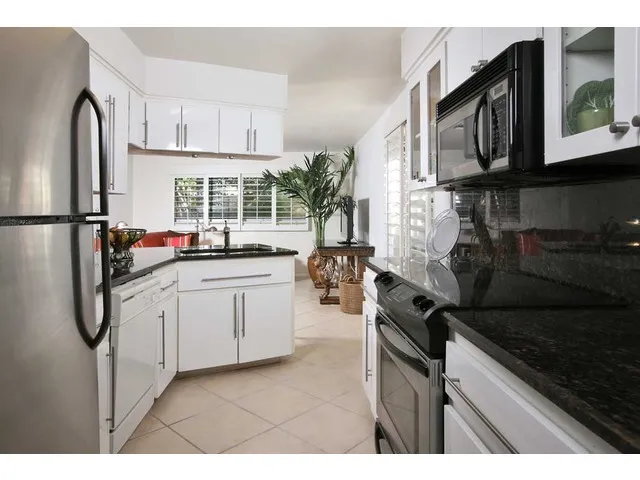 Granite counter tops, with bar open to TV room, tile throughout