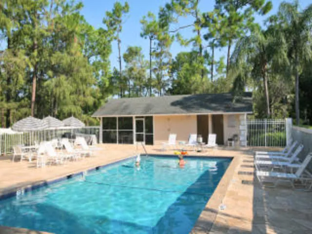 Just steps to Heated pool, screened pool house with kitchen and BBQ
