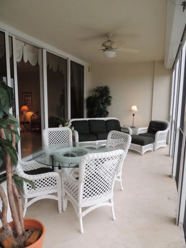 Large lanai features automatic shutters-dining table and living room set