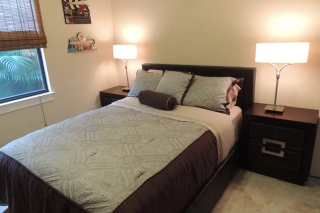 The guest room 2 has a queen bed with a flat screen tv