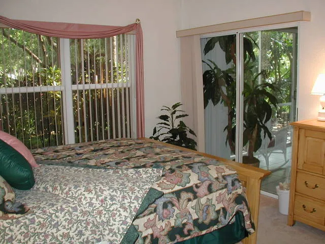 Master bedroom with queen bed, dresser, nightstand and TV