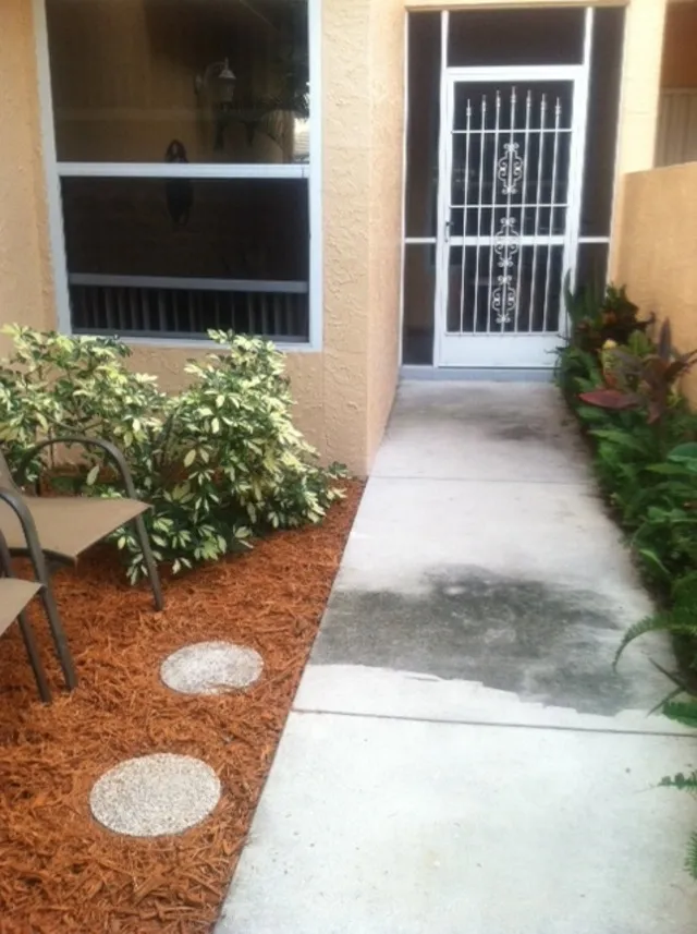 Private courtyard entrance with small screened porch