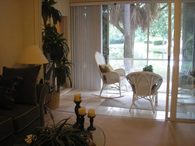 Living room looking out through lanai at lake