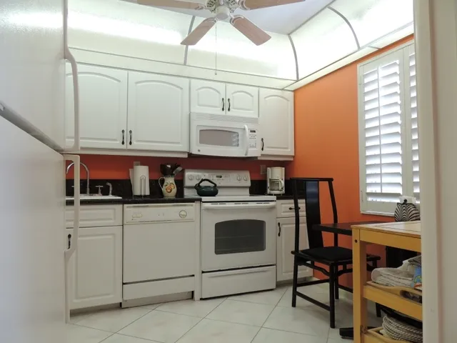 Kitchen features granite and new appliances
