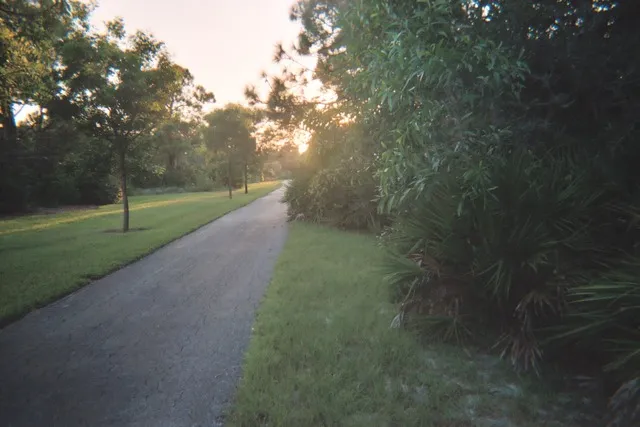 View west down walking trail to boardwalk and back bay with gazebo