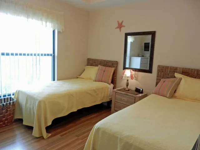 Twin bedroom with chest & TV.