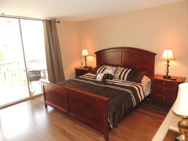 Mastersuite has hardwood flooring,king bed, flat screen tv, access to lanai