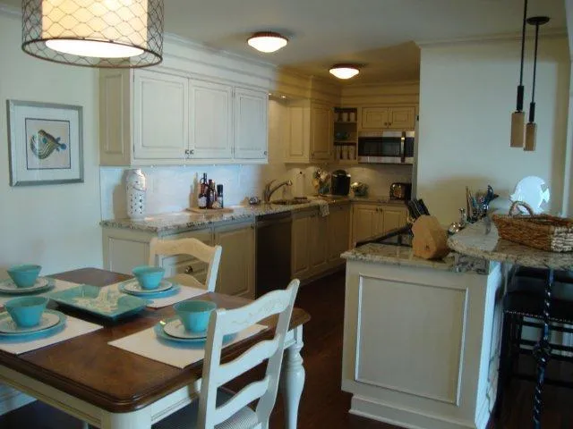 Dinig area & kitchen. Custom cabinets, granite & stainless appliances.