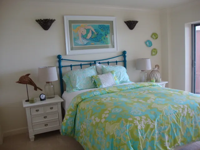 Cozy guest room with stylish decor. Sliders open to balcony.