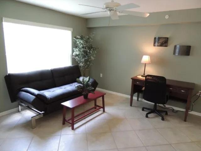Open den area features a futon with desk area 