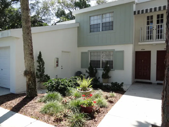 Exterior of 1st floor condo with attached garage.