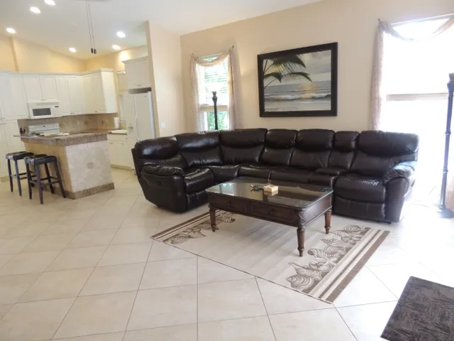 Living room has a leather sectional sofa