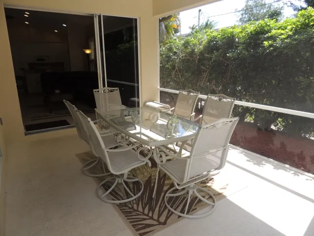 Screened lanai - dine pool side a gas grill is provided