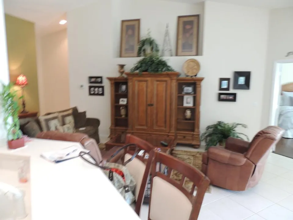 The living room features an entertainment center w/ flat screen tv & leather seating