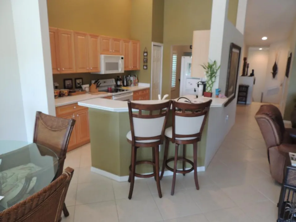 The kitchen has a breakfast bar with stools and is right in the middle of the condo! 