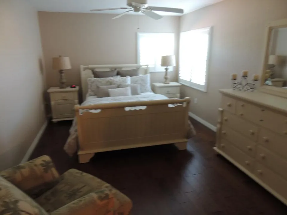 The spacious guest suite has a queen bed, with sitting area, closet and access to guestr bath