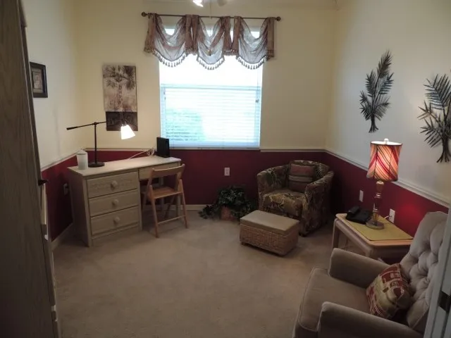 The den features a desk, wi fi, 2 chairs, and flat screen tv