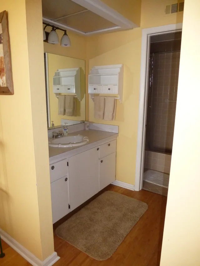 Ensuite vanity, toilet and shower in separate room.