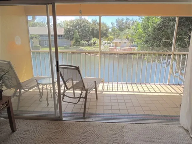 Lanai overlooking lake and pool is located across the lake