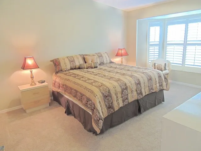 Master bedroom with king bed, private bath, & sitting area w/views of the pool