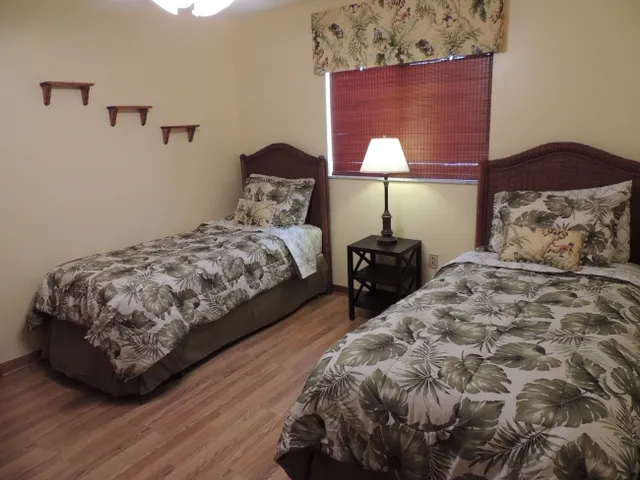 Guest room 1 has twin bed & hardwood flooring