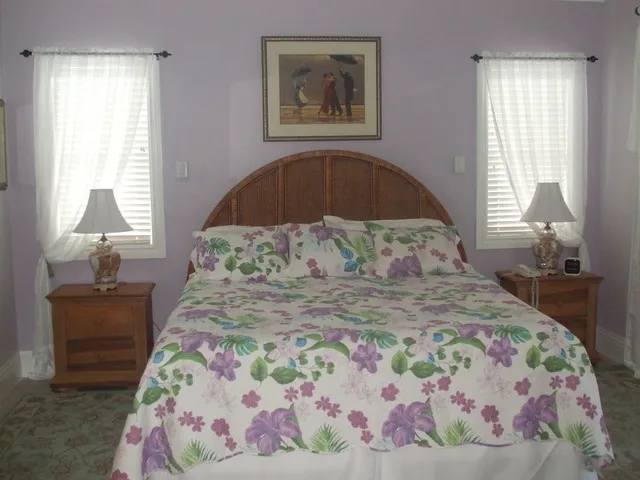Large bright bedroom opens to Lanai and pool.