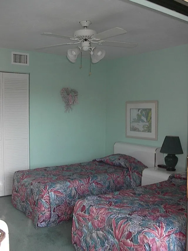 GUEST BDRM HAS TWIN BEDS,LARGE CLOSET,RM DARKENING DRAPES/DOORWALL TO LANAI