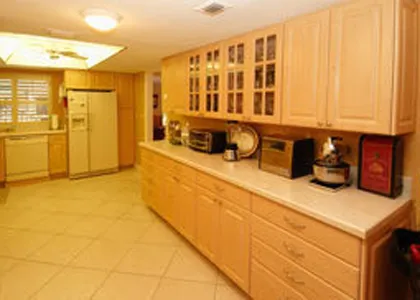 Expanded cabinets and counter space from front to back into lanai & office.